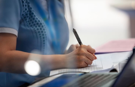 person filling up a document